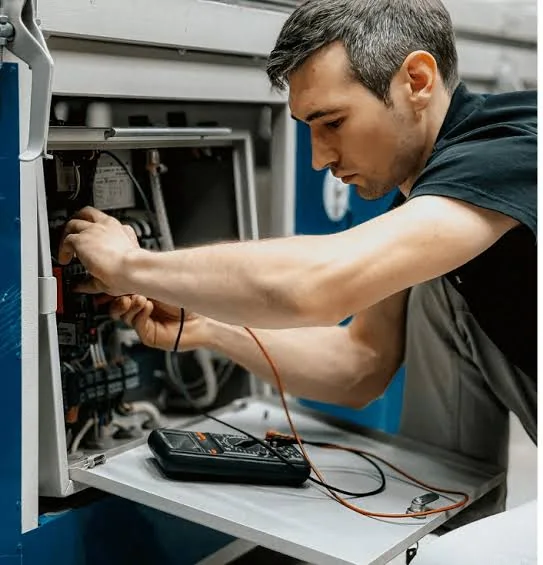 Technician using a meter to diagnose indoor heating equipment