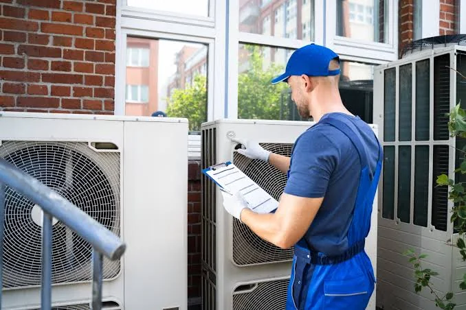 HVAC technician reviewing outdoor equipment for an installation